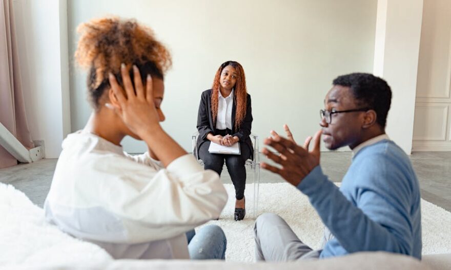 A couple in therapy session with a mental health professional indoors. - Photo by Antoni Shkraba Studio on Pexels