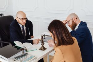 Lawyer consulting clients in a modern office setting, serious discussion. - Photo by https://kaboompics.com/ on Pexels